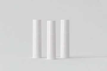Three upright white lip balm tubes mockup, standing side by side, clean and minimal design, blank label, on a smooth light gray background