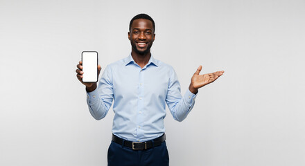 Smiling African American Businessman Proudly Displays Mobile Phone with Blank Screen for Your Business Presentation