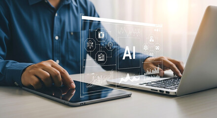 Man using laptop and tablet with ai interface overlay displayed on screen in bright office setting