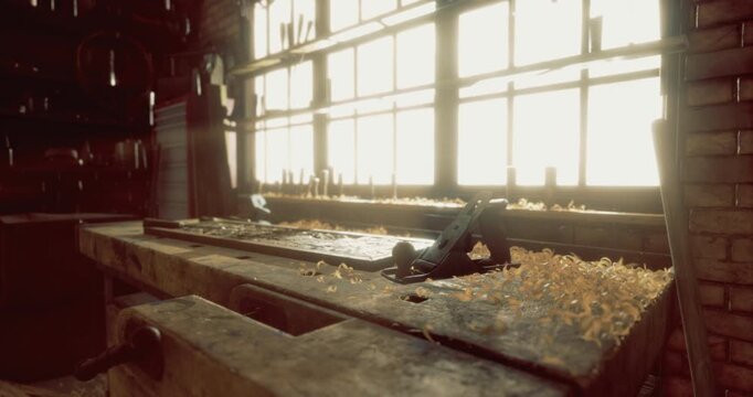 Sunlight streams through large windows in a woodworking workshop, highlighting a weathered workbench covered in wood shavings and tools used for crafting wooden items.