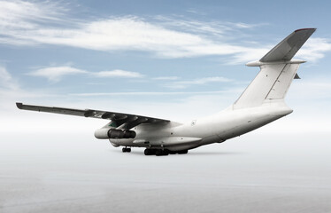 White wide body transport cargo aircraft isolated on bright background with sky