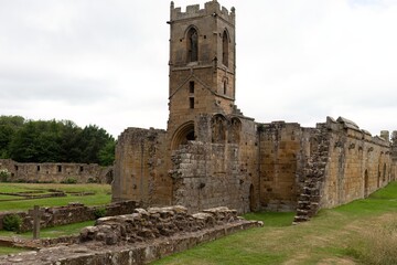 the ruins of an old stone building with a prominent tower in Mount Grace Priory - East Harlsey - North Yorkshire - UK