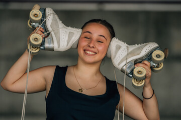 figure skating athlete with skates smiling outdoors