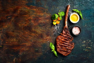 Tomahawk Black Agus steak with sea salt, butter and spices. Juicy steak grilled. Top view.
