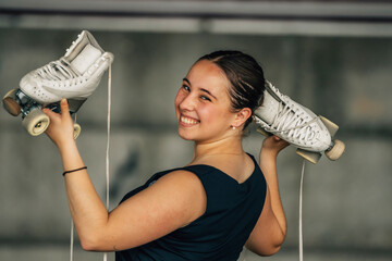 figure skating athlete with skates smiling outdoors