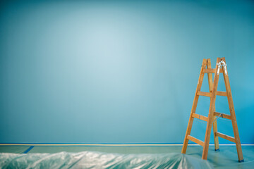 Wooden ladder stands in a room during painting works © Zamrznuti tonovi