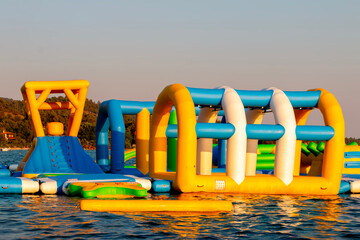 Water inflatable attraction on the seaside. Toy on the sea. Fun aqua park for children.