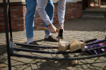 Man Chopping Firewood with Axe Outdoors
