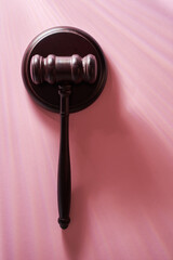 top view of gavel hammer against pink background with copoy space.