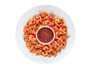 Shrimp with red salsa in a plate isolated over white background