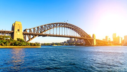 Obraz premium Panoramic view of a steel arch bridge over water, cityscape in the background, bright sunny day