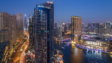 Evening illumination of Dubai Marina day to night aerial timelapse, UAE.