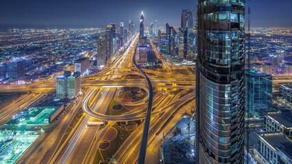 Scenic Dubai downtown skyline at night timelapse. Rooftop view of Sheikh Zayed road with numerous...