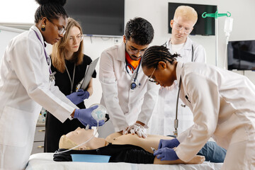 Doctors practicing cardiopulmonary resuscitation on a medical manikin