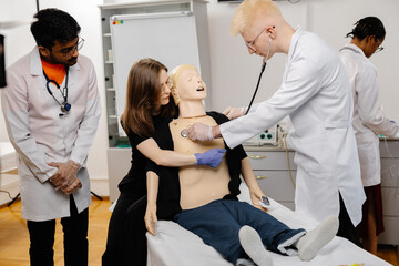 Medical Students Practicing on Anatomical Model with Stethoscope