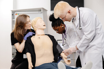 Medical Students Practicing on Anatomical Model with Stethoscope