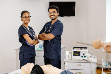 Medical Students Practicing CPR Training with Defibrillator and Mannequin