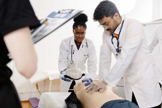 Doctors practicing cardiopulmonary resuscitation on a medical manikin
