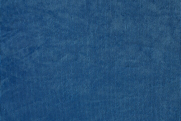 Blue textured fabric with fine vertical lines in detailed close-up view