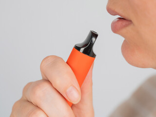 Caucasian woman smoking disposable vape. 