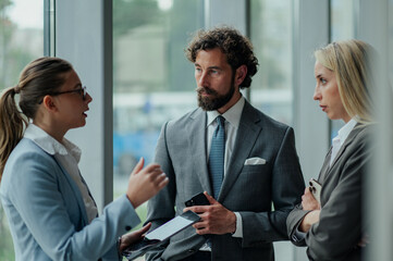 Businesspeople discussing work in office corridor