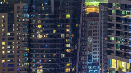 Obraz premium Scenic glowing windows of skyscrapers at evening timelapse