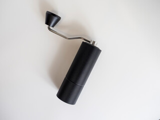 manual coffee grinder black on a white background, top view, flat lay