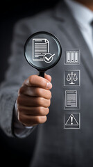 Person holding magnifying glass over document with icons for legal compliance and risk assessment