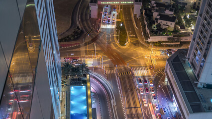 Aerial view of a road intersection in a big city night timelapse.