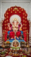 Ganesha hindu god idol statue with offerings and decorations for hindu festival celebration puja altar