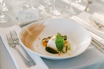 Fine dining dish presented elegantly at a formal event showcasing a combination of flavors and textures of fresh mozzarella salad.