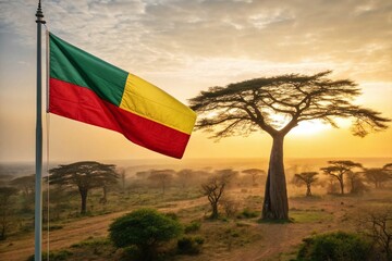 Flag of Benin waving in the sunrise over a savanna landscape with baobab trees