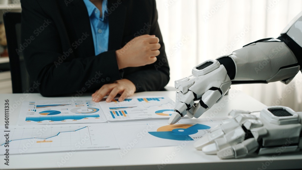 Poster a modern office scene featuring a human and a robotic hand collaborating on data analysis. focus on 
