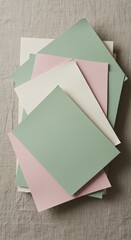 Pastel Colored Square Paper Stack: Pink, Green, Cream, Beige Background. Abstract Backdrop, Minimalist Design, Flat Lay, Top View. Soft Tones, Gentle Colors.