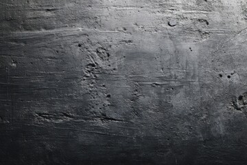 Textured black concrete wall with scratches and imperfections for industrial style design, modern architecture concepts, and urban decor inspiration