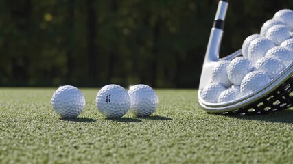Golf ball resting on artificial turf near golf club and ball basket, showcasing preparation moments before precision shot during practice session