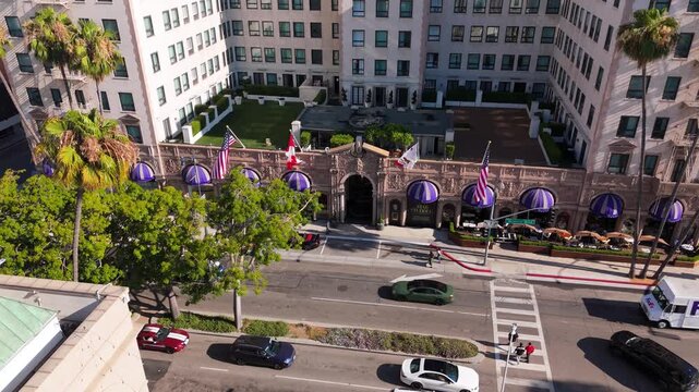 Luxury hotel exterior with flags and purple canopies, July 14, 2025