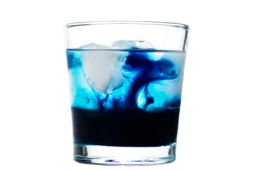 a glass of blue liquid with a white background