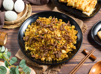 Savory Curry Beef Egg Fried Rice on Black Plate with Scallions side view of hong kong food