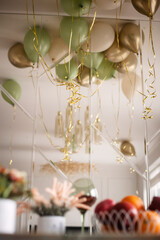background for a holiday in beige and green tones consisting of balloons
