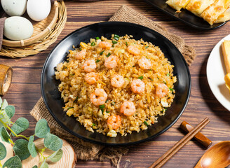 Delicious Shrimp and Egg Fried Rice on a Black Plate with Scallions side view of hong kong food