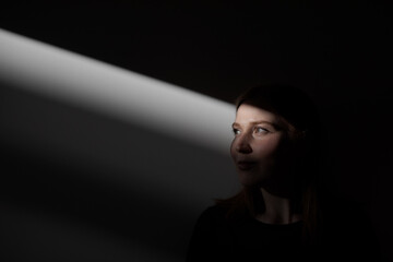 young woman in the dark