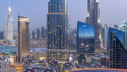 Dubai downtown skyline day to night timelapse with tallest building and Sheikh Zayed road traffic,...