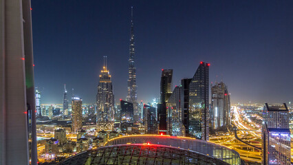 Fototapeta premium Dubai downtown skyline night timelapse with tallest building and Sheikh Zayed road traffic, UAE