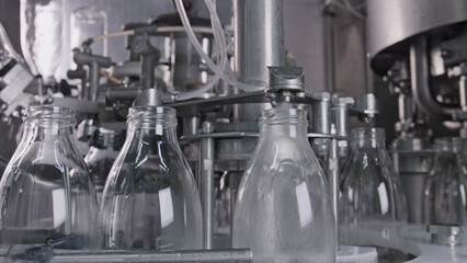 Empty glass bottles rotating on industrial