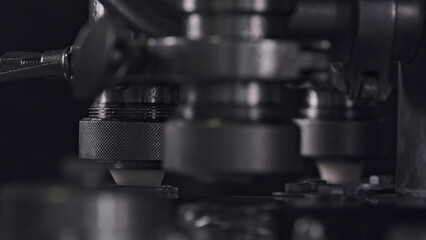 Industrial machine pressing cheese molds in dairy