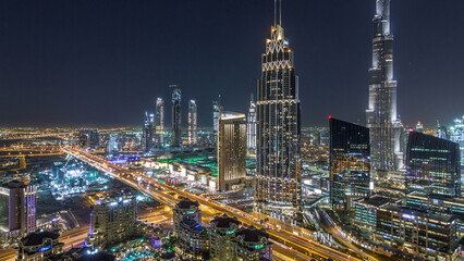 Dubai downtown skyline night timelapse with tallest building and road traffic, UAE