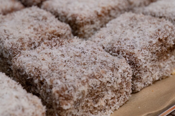 Homemade lamingtons coated in coconut flakes
