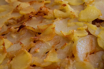 Closeup of baked sliced potatoes
