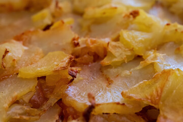 Crispy baked potato slices close-up
